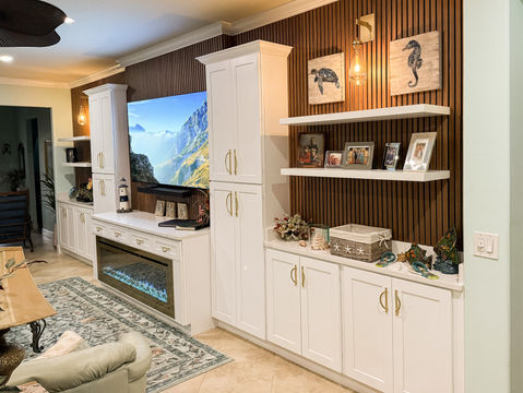 Interior remodeling project with fireplace feature wall and built-in cabinetry by Hipo Homes
