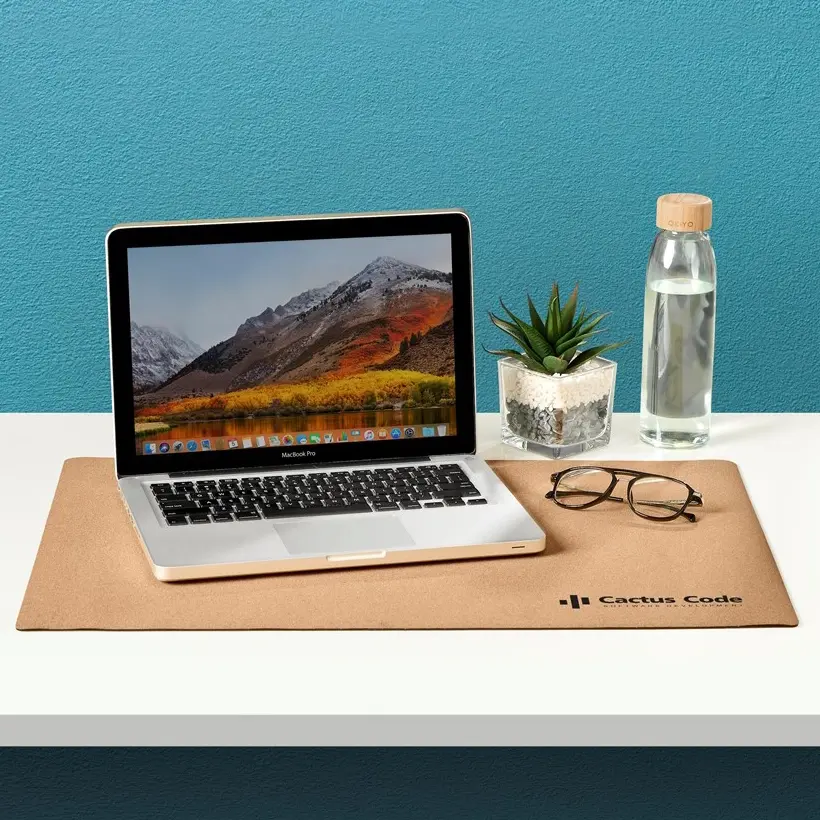 Branded cork giant mousepad with laptop on top.webp