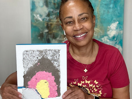 Artist holding artwork