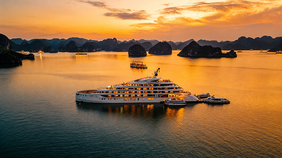 Luxury yacht on golden water at sunset, with limestone islands and small boats in a calm, glowing bay.