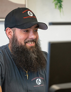 Owner Matthew Rose sitting at his desk at the new office.
