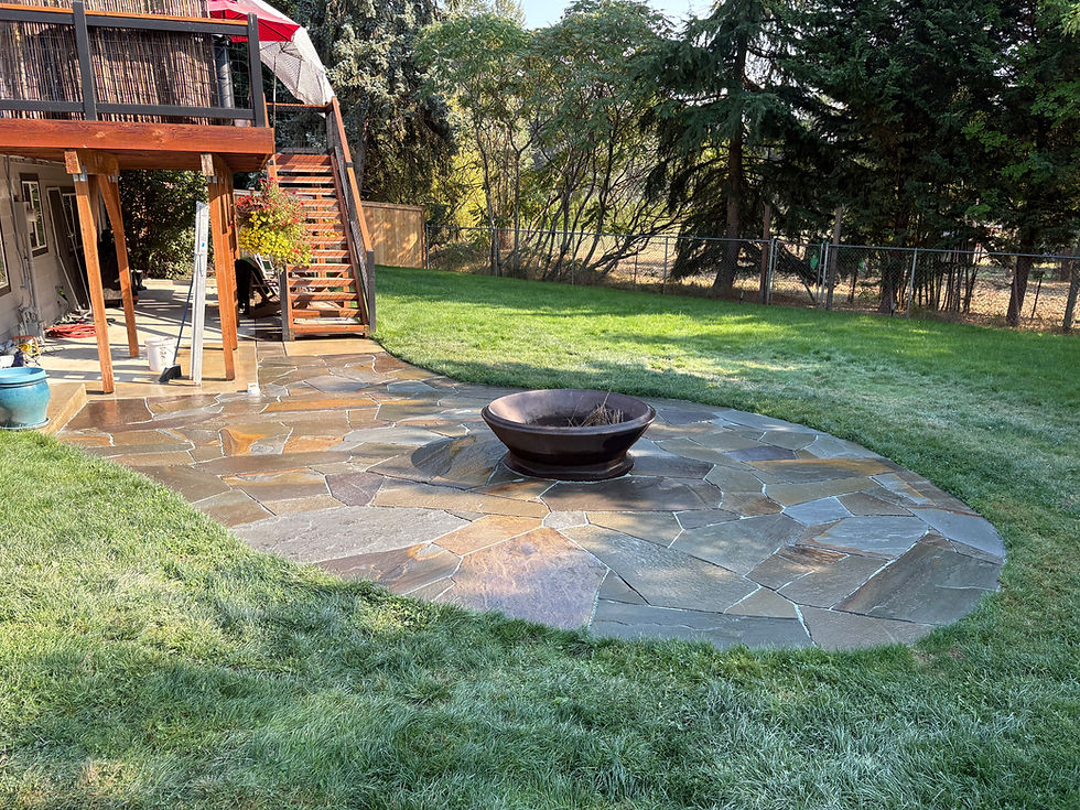 a flagstone patio with a fire pit