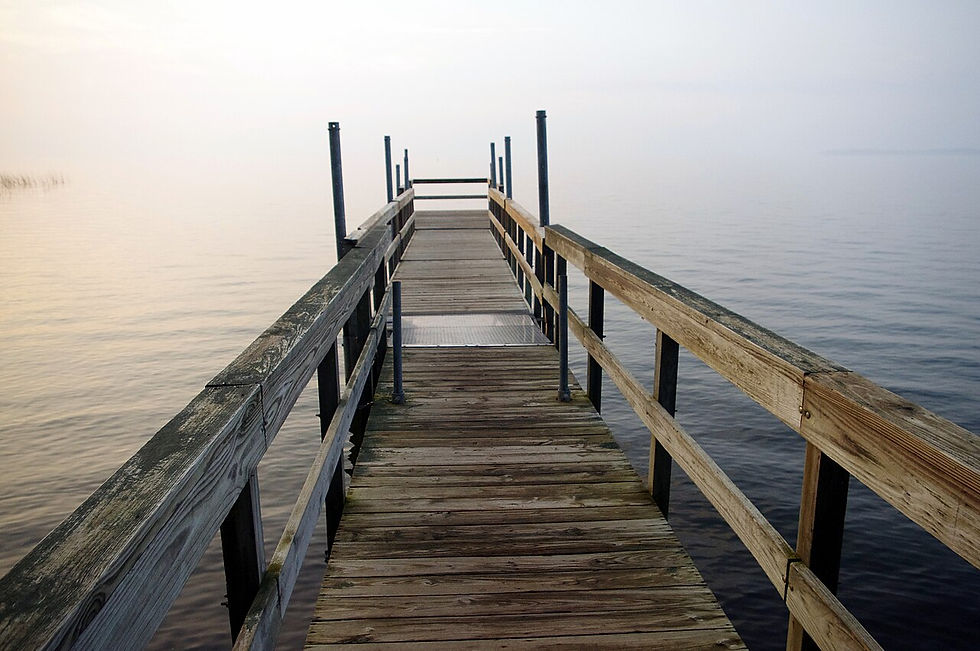 Wooden fishing pier stretching into calm Mille Lacs Lake at Father Hennepin State Park