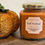 Thumbnail: Burnt Orange color Fall Festival soy candle, 9oz Oval Hexagonal, gold lid, white label shown near Fall Decoration