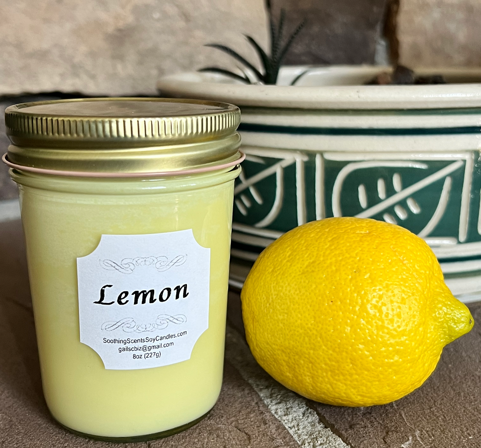 Light yellow lemon scented soy candle in country jelly jar with a lemon