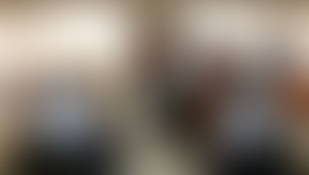 Corporate professional sitting at a desk looking exhausted and rubbing temples at 3 PM, illustrating the negative impact of poor diet on employee productivity and nutrition