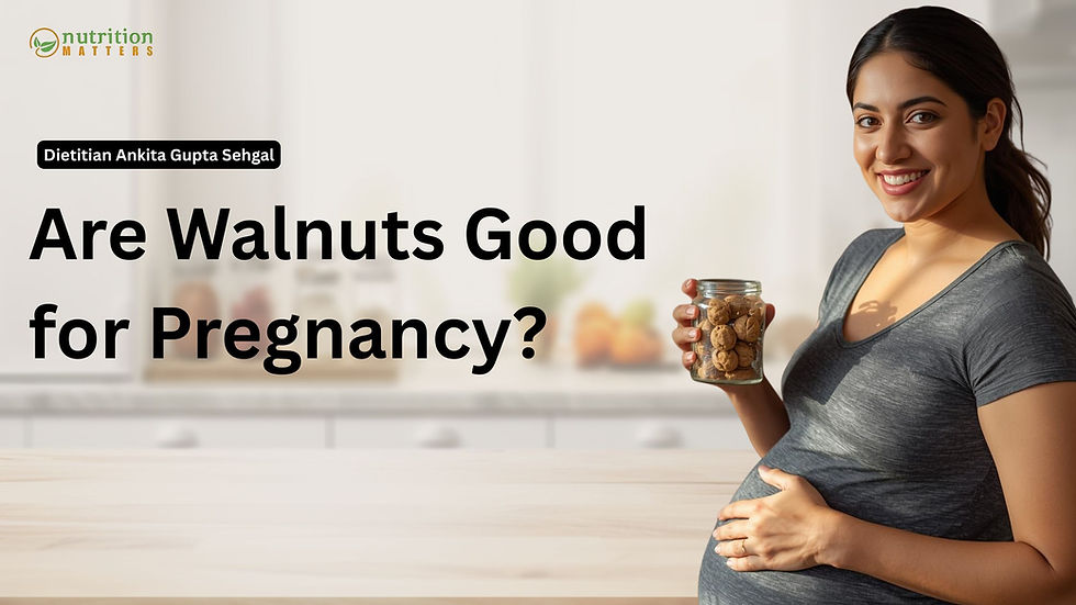 Bowl of soaked walnuts with a pregnant woman’s hand reaching for one, symbolizing healthy pregnancy nutrition