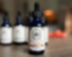 Womb Restore Herbal Tincture in focus with other herbal tinctures softly blurred in background