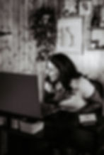 Woman laughing hard sitting at her desk.