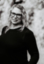 Woman in glasses smiling.