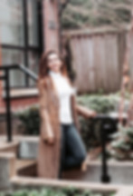 Woman waling down the stairs outside.