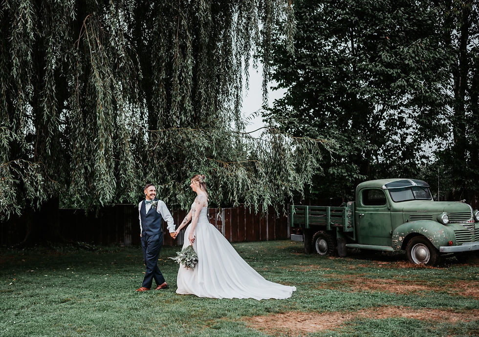 Newlyweds strolling under a willow tree in Chilliwack, BC
