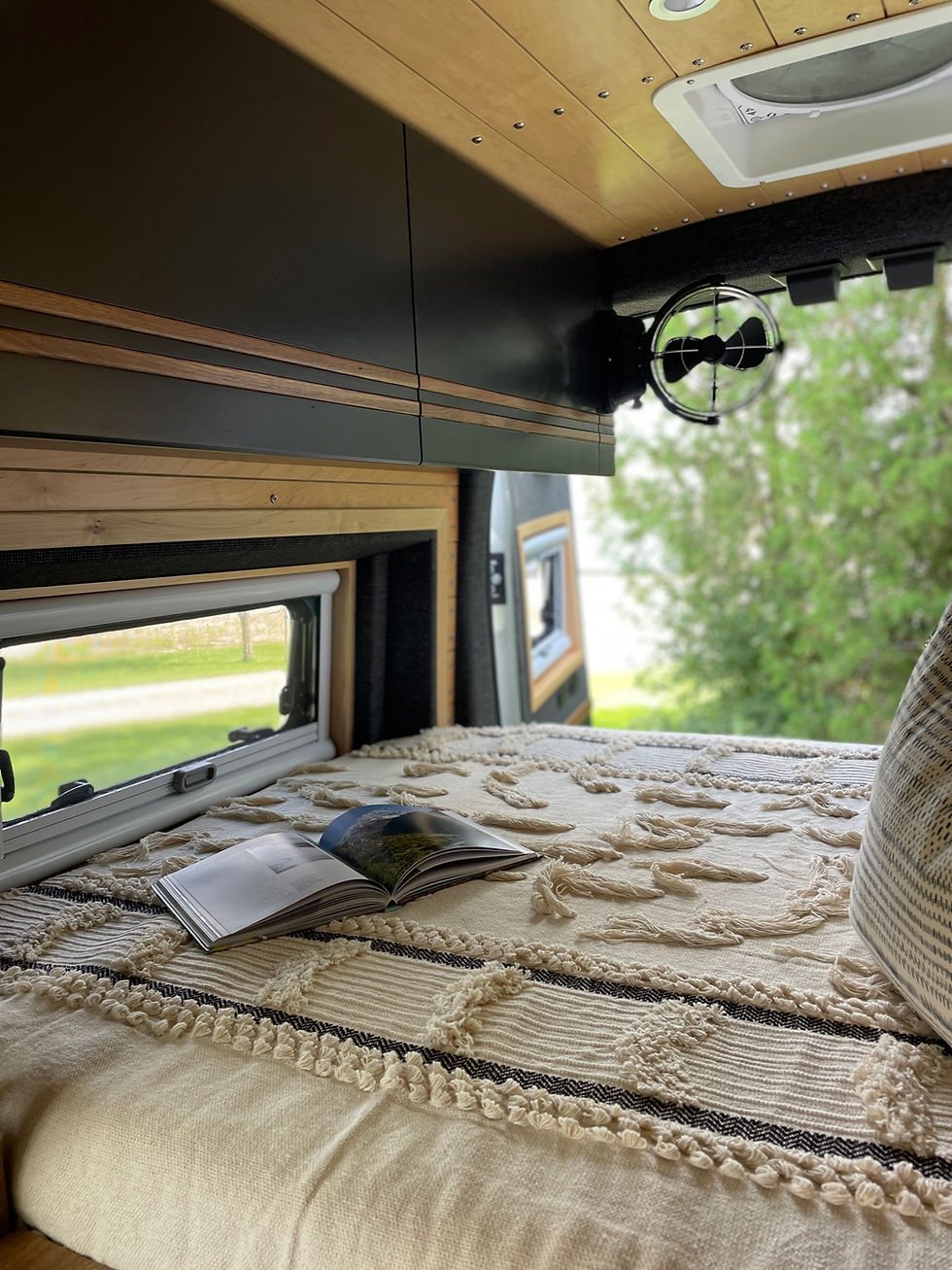 High angle view of a custom camper van parked on a mountain overlook at sunset