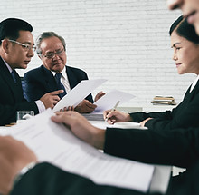 Asian lawyers discussing on legal case with document contract