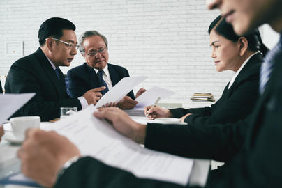 Asian lawyers discussing on legal case with document contract