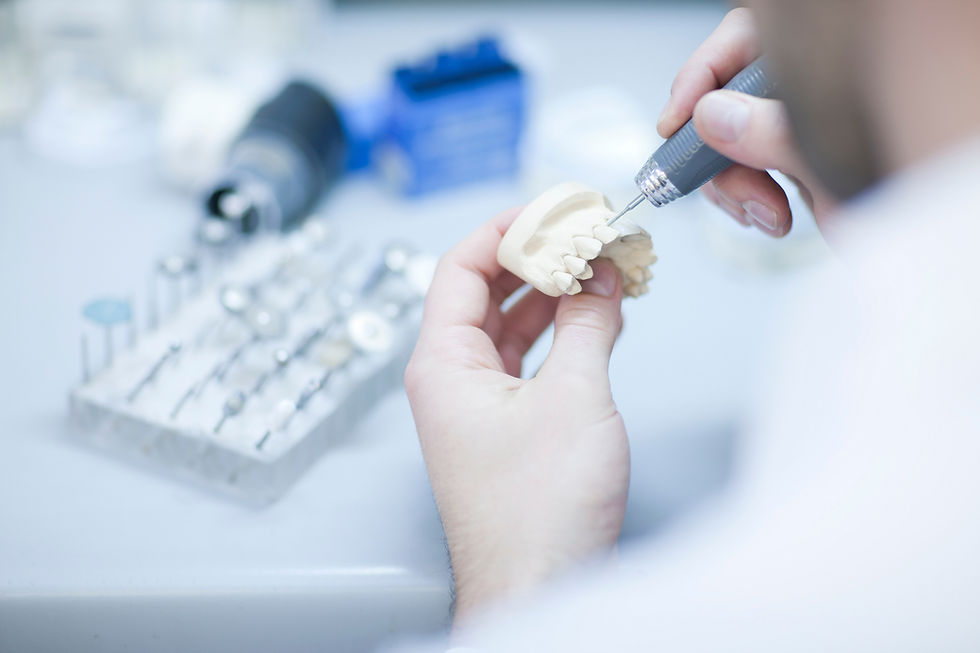 Dental technician working on denture