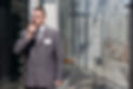 security guard standing at the glass door entrance of a corporate building