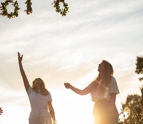 Women Reaching Wreaths