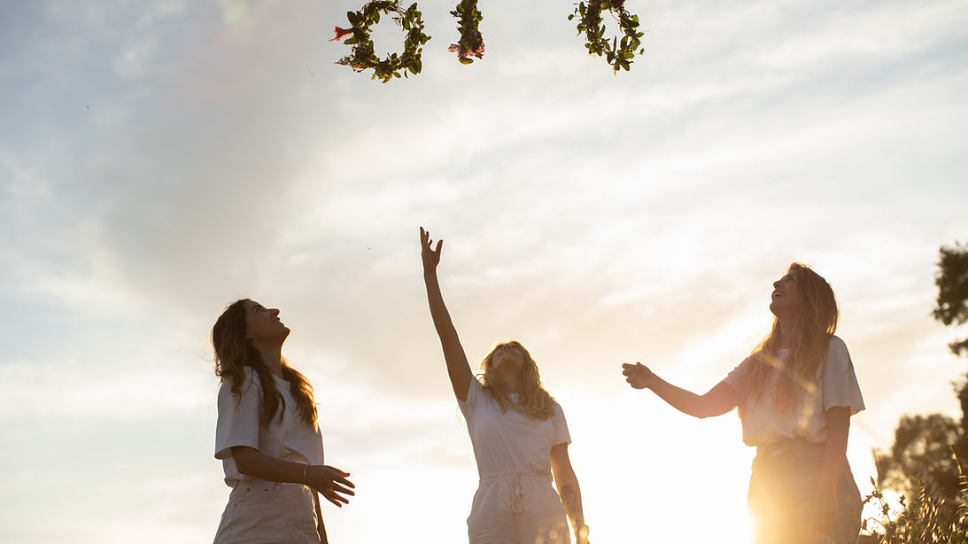 Women Reaching Wreaths