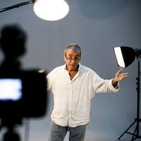 Mature actor, gray hair, white relaxed shirt, performs monologue on-camera