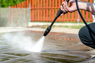 Close-up of a man's hand cleaning the patio with pressure washing