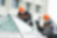two industrial builder workers at outdoors window installation