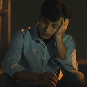 Man drinking alone outside, symbolizing the quiet battle with Depression many men face.