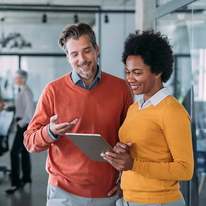 Shot of two coworkers having a discussion in modern office. Businessman and businesswoman