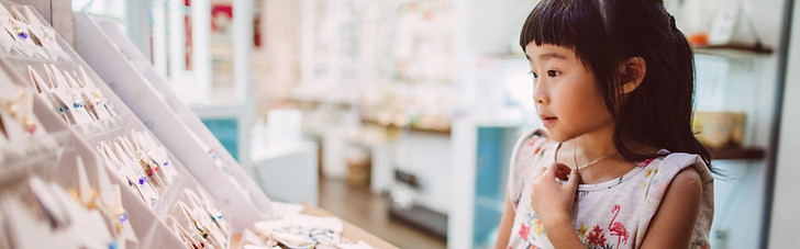 A girl looking at souvenirs.pg