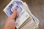 holding british pounds