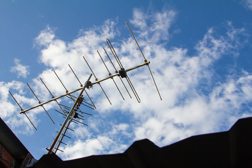 A television antenna on a house rooftop