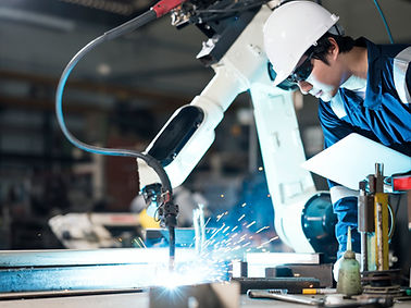 A man using a machine to cut iron bar