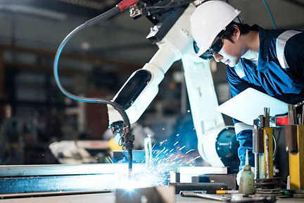 A man using a machine to cut iron bar