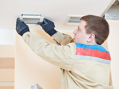 industrial builder installing ventilation or air conditioning filter holder in ceiling
