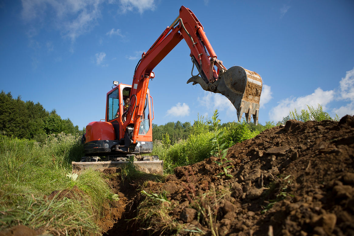 Man digging a trench with a digger