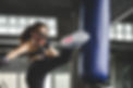 A woman kicking a sandbag