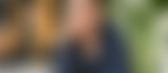 mulher com caneta na mão pensando no planejamento de comunicação da empresa