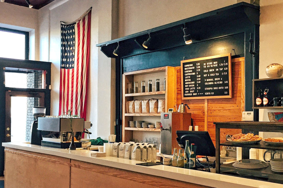 Illustrative example showcasing modern café design focused on customer flow, branding, and a clean, contemporary aesthetic.