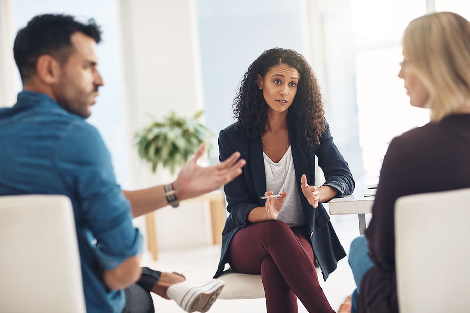 A couple having an argument during a counseling session with a therapist