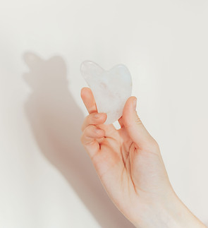 Hand holding gua sha