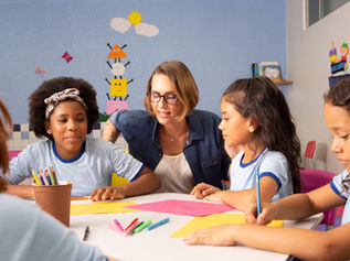 Teacher checking pupils are using tools safety.