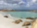 Calm sea and sandy beach symbolizing spiritual healing and inner peace, as guided by Liara Covert, intuitive spiritual life coach.