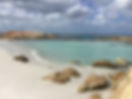 Calm sea and sandy beach symbolizing spiritual healing and inner peace, as guided by Liara Covert, intuitive spiritual life coach.