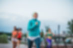 A group of women running a race outdoors in the city. 