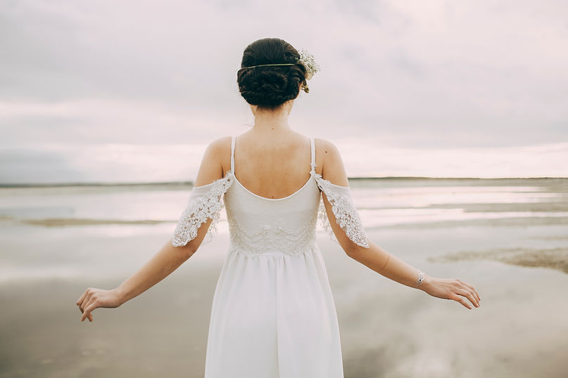 Bride facing serene lake
