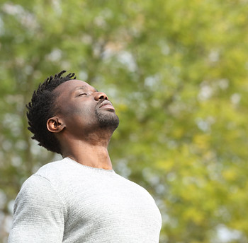 man facing up in the daylight, chest up, yoga, meditation