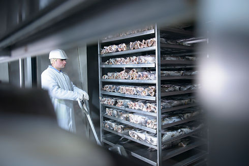Stacked white plastic crates inside an industrial cold storage facility