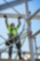 Caucasian worker on scaffolding on construction site