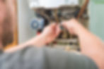 Technician repairing gas boiler for a customer