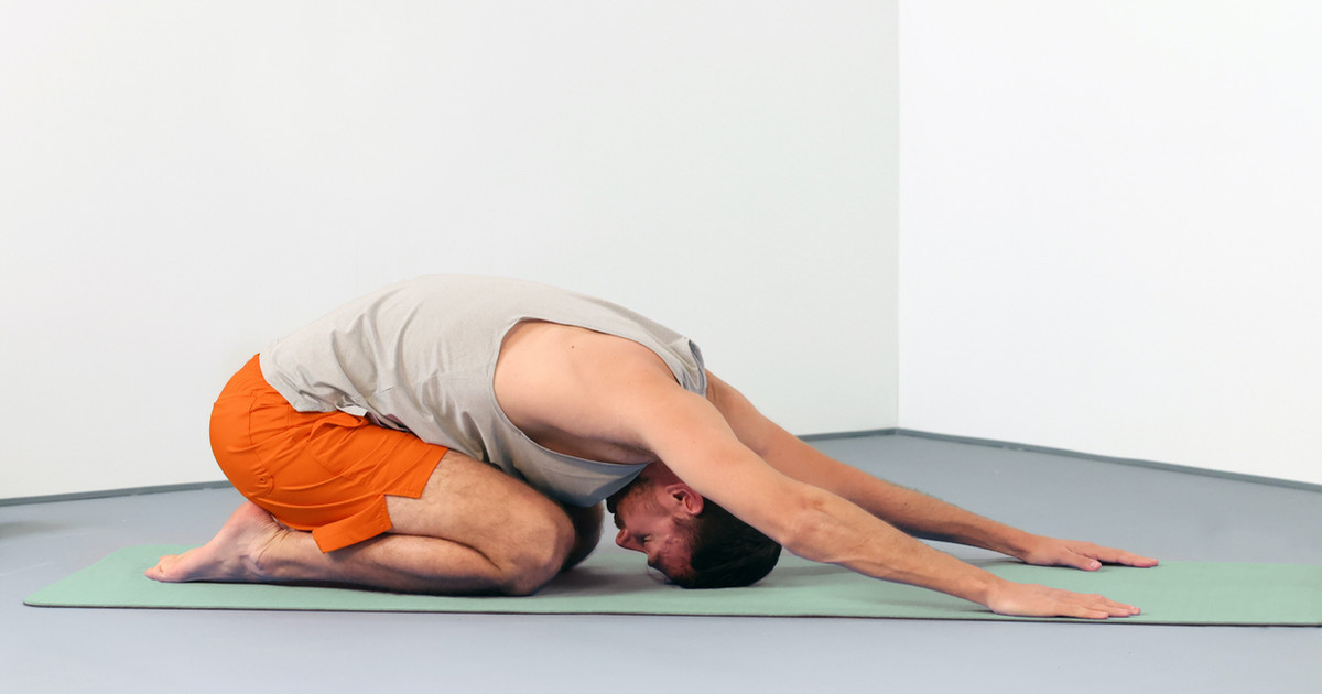 A person performing gentle stretching exercises in a calm home environment, improving flexibility and confidence while living with persistent pain.